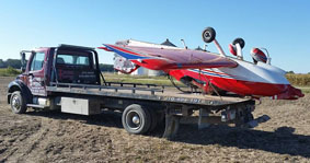 Boats being transported on a flatbed truck